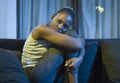 Young African American woman suffering depression - sad and depressed black teenager girl in pain at home sofa couch feeling Royalty Free Stock Photo