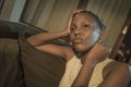Young African American woman suffering depression - sad and depressed black teenager girl in pain at home sofa couch feeling Royalty Free Stock Photo