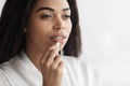 Young african american woman taking medicine, eating beauty supplement pill, closeup, free space Royalty Free Stock Photo