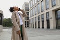 young african american woman talking on mobile phone outside with her head thrown back and laughing Royalty Free Stock Photo