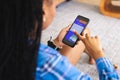 Young African American woman uses a smartphone, booking a vacation online Royalty Free Stock Photo