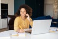 Young African-American woman using laptop at home Royalty Free Stock Photo