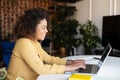 Young African-American woman using laptop at home Royalty Free Stock Photo