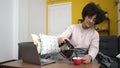 Young african american woman using laptop sitting on sofa at home Royalty Free Stock Photo