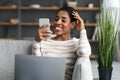 Young African American Woman Using Smartphone And Laptop At Home Royalty Free Stock Photo