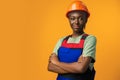 Young african american woman wearing architect hardhat against yellow background Royalty Free Stock Photo