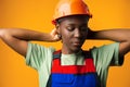 Young african american woman wearing architect hardhat against yellow background Royalty Free Stock Photo