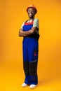 Young african american woman wearing architect hardhat against yellow background Royalty Free Stock Photo