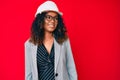 Young african american woman wearing architect hardhat looking to side, relax profile pose with natural face and confident smile Royalty Free Stock Photo