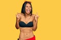 Young african american woman wearing bikini shouting with crazy expression doing rock symbol with hands up Royalty Free Stock Photo