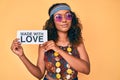 Young african american woman wearing bohemian and hippie style holding made with love message thinking attitude and sober