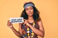 Young african american woman wearing bohemian and hippie style holding you are magical message thinking attitude and sober