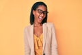 Young african american woman wearing business clothes winking looking at the camera with sexy expression, cheerful and happy face Royalty Free Stock Photo