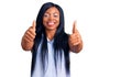 Young african american woman wearing casual clothes approving doing positive gesture with hand, thumbs up smiling and happy for Royalty Free Stock Photo