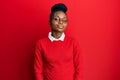 Young african american woman wearing casual clothes and glasses relaxed with serious expression on face Royalty Free Stock Photo