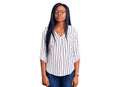 Young african american woman wearing casual clothes and glasses relaxed with serious expression on face Royalty Free Stock Photo