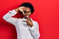 Young african american woman wearing casual clothes and glasses smiling making frame with hands and fingers with happy face Royalty Free Stock Photo