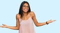 Young african american woman wearing casual clothes and glasses smiling showing both hands open palms, presenting and advertising Royalty Free Stock Photo