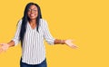 Young african american woman wearing casual clothes and glasses smiling showing both hands open palms, presenting and advertising Royalty Free Stock Photo