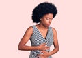 Young african american woman wearing casual clothes with hand on stomach because indigestion, painful illness feeling unwell