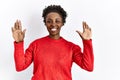 Young african american woman wearing casual clothes over isolated background showing and pointing up with fingers number ten while Royalty Free Stock Photo