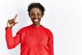 Young african american woman wearing casual clothes over isolated background smiling and confident gesturing with hand doing small Royalty Free Stock Photo