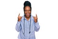 Young african american woman wearing casual clothes shouting with crazy expression doing rock symbol with hands up Royalty Free Stock Photo