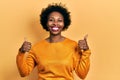 Young african american woman wearing casual clothes success sign doing positive gesture with hand, thumbs up smiling and happy Royalty Free Stock Photo