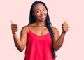 Young african american woman wearing casual clothes success sign doing positive gesture with hand, thumbs up smiling and happy Royalty Free Stock Photo