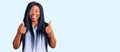 Young african american woman wearing casual clothes success sign doing positive gesture with hand, thumbs up smiling and happy Royalty Free Stock Photo