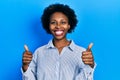 Young african american woman wearing casual clothes success sign doing positive gesture with hand, thumbs up smiling and happy Royalty Free Stock Photo