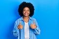 Young african american woman wearing casual clothes success sign doing positive gesture with hand, thumbs up smiling and happy Royalty Free Stock Photo