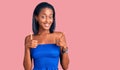 Young african american woman wearing casual summer clothes success sign doing positive gesture with hand, thumbs up smiling and Royalty Free Stock Photo