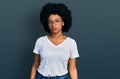 Young african american woman wearing casual white t shirt relaxed with serious expression on face Royalty Free Stock Photo