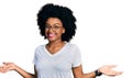 Young african american woman wearing casual white t shirt smiling showing both hands open palms, presenting and advertising Royalty Free Stock Photo