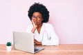 Young african american woman wearing doctor stethoscope working using computer laptop thinking looking tired and bored with Royalty Free Stock Photo