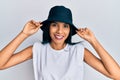 Young african american woman wearing fashion hat smiling with a happy and cool smile on face Royalty Free Stock Photo