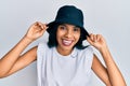 Young african american woman wearing fashion hat smiling and laughing hard out loud because funny crazy joke Royalty Free Stock Photo