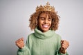 Young african american woman wearing golden crown of queen over isolated white background very happy and excited doing winner Royalty Free Stock Photo