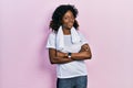 Young african american woman wearing sportswear and towel happy face smiling with crossed arms looking at the camera Royalty Free Stock Photo