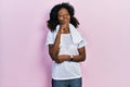 Young african american woman wearing sportswear and towel looking confident at the camera smiling with crossed arms and hand Royalty Free Stock Photo