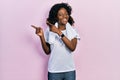 Young african american woman wearing sportswear and towel smiling and looking at the camera pointing with two hands and fingers to Royalty Free Stock Photo