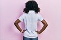 Young african american woman wearing sportswear and towel standing backwards looking away with arms on body Royalty Free Stock Photo