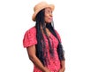 Young african american woman wearing summer hat smiling looking to the side and staring away thinking Royalty Free Stock Photo