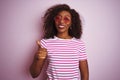 Young african american woman wearing t-shirt and sunglasses over isolated pink background doing happy thumbs up gesture with hand Royalty Free Stock Photo