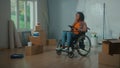 Young African American woman in a wheelchair is planning a renovation using a digital tablet. Disabled woman browses Royalty Free Stock Photo