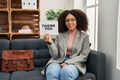 Young african american woman working at consultation office holding thank you banner looking positive and happy standing and Royalty Free Stock Photo