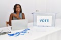 Young african american woman working at political election sitting by ballot pointing aside worried and nervous with forefinger, Royalty Free Stock Photo
