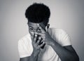 Young african american young man looking scared and shocked at something. Human expressions Royalty Free Stock Photo