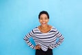 Young african american young woman smiling against blue wall Royalty Free Stock Photo